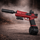 Rød Gecko Tracerlight Gel Blaster med tracer-muffer og rød dot-sigte på en grusvej.